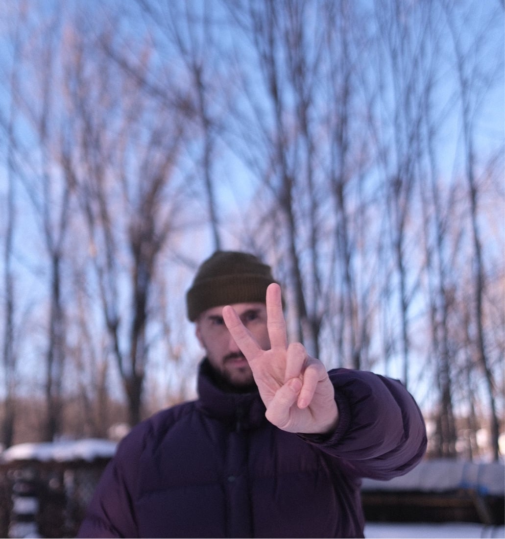 Sean throwing up a peace sign in the snow